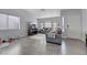 Bright living room with gray couches, hardwood floors, and large windows at 4722 Casa Bonita Dr, North Las Vegas, NV 89032