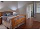 Main bedroom with wood frame bed and hardwood floors at 4750 Obannon Dr # D, Las Vegas, NV 89102