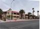 Attractive exterior of a two-story building with Spanish-style architecture and palm trees at 4750 Obannon Dr # D, Las Vegas, NV 89102