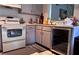 Kitchen corner with white appliances and gray cabinets at 4750 Obannon Dr # D, Las Vegas, NV 89102