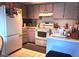 Galley kitchen with white appliances and light gray cabinets at 4750 Obannon Dr # D, Las Vegas, NV 89102