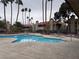 Community pool with surrounding patio furniture at 4750 Obannon Dr # D, Las Vegas, NV 89102