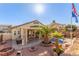 Landscaped backyard features a sparkling pool and spacious patio at 4826 Polar Lights Ct, Las Vegas, NV 89130