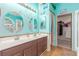 Double vanity bathroom with light teal walls at 4826 Polar Lights Ct, Las Vegas, NV 89130