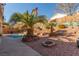 Landscaped backyard with a refreshing pool and palm trees at 4826 Polar Lights Ct, Las Vegas, NV 89130