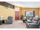 Spacious living room with gray recliners and a neutral color scheme at 4826 Polar Lights Ct, Las Vegas, NV 89130