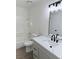 Well-lit bathroom featuring a marble countertop, black fixtures, and a shower-tub combination at 4928 Nellie Springs Ct, Las Vegas, NV 89110