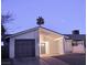 Well-kept single-story home with a gray garage door, stucco walls, and desert landscaping at 4928 Nellie Springs Ct, Las Vegas, NV 89110