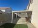 Covered patio with artificial turf and rocking chairs at 5005 Prairie Springs Ct, Las Vegas, NV 89130