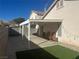 Small backyard with covered patio and artificial turf at 5005 Prairie Springs Ct, Las Vegas, NV 89130