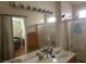 Bathroom with double sinks, large mirror, and a shower/tub combo at 5005 Prairie Springs Ct, Las Vegas, NV 89130