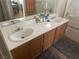 Bathroom with double sinks and light wood cabinets at 5005 Prairie Springs Ct, Las Vegas, NV 89130