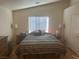 Comfortable bedroom with large window and wood flooring at 5005 Prairie Springs Ct, Las Vegas, NV 89130