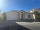 Two-story house with white exterior, attached garage, and landscaping at 5005 Prairie Springs Ct, Las Vegas, NV 89130