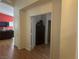 Home hallway with wood-look floors and access to storage at 5005 Prairie Springs Ct, Las Vegas, NV 89130