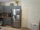 Kitchen features stainless steel refrigerator and blue cabinets at 5005 Prairie Springs Ct, Las Vegas, NV 89130