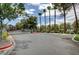 Gated entrance to community with palm trees and parking at 5006 S Rainbow Blvd # 103, Las Vegas, NV 89118