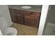 Bathroom with granite countertop, wood cabinets, and tile floor at 5080 Indian River Dr # 403, Las Vegas, NV 89103