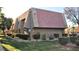 Exterior view of building with Spanish tile roof and landscaping at 5080 Indian River Dr # 403, Las Vegas, NV 89103