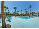 Community pool with lounge chairs and palm trees under sunny skies at 5080 Indian River Dr # 403, Las Vegas, NV 89103