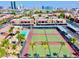 Aerial view of community tennis courts and pool with city view at 5080 Indian River Dr # 403, Las Vegas, NV 89103