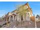 Two-story home with tile roof, stone accents, and landscaped yard at 524 Celebratory Pl, Henderson, NV 89011