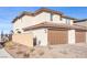 Two-car garage with brown doors and brick facade at 524 Celebratory Pl, Henderson, NV 89011