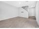 Open living room with wood-look tile flooring and staircase at 524 Celebratory Pl, Henderson, NV 89011