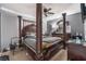 Main bedroom with a large, dark-wood post bed and plenty of closet space at 5916 Magic Oak St, North Las Vegas, NV 89031