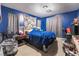 Blue bedroom with a double bed and ample closet space at 5916 Magic Oak St, North Las Vegas, NV 89031