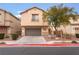 Two-story house with attached garage and landscaped front yard at 5916 Magic Oak St, North Las Vegas, NV 89031