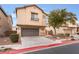 Two-story house with attached garage and landscaped front yard at 5916 Magic Oak St, North Las Vegas, NV 89031