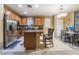 Eat-in kitchen with island, stainless steel appliances, and oak cabinets at 5916 Magic Oak St, North Las Vegas, NV 89031