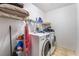 Laundry room with washer, dryer, and shelving for storage at 5916 Magic Oak St, North Las Vegas, NV 89031