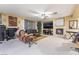 Living room with a fireplace, sectional sofa, and large TV at 5916 Magic Oak St, North Las Vegas, NV 89031