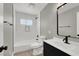 Modern bathroom with white tile and dark vanity at 649 Federal St, Henderson, NV 89015