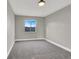 Spacious bedroom with gray walls, carpet flooring and a window at 649 Federal St, Henderson, NV 89015