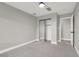 Simple bedroom with gray walls, carpet flooring and mirrored closet doors at 649 Federal St, Henderson, NV 89015