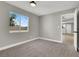 Bright bedroom with gray walls, carpet flooring, and a window with natural light at 649 Federal St, Henderson, NV 89015