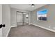 Cozy bedroom with gray walls, carpet flooring, and mirrored closet doors at 649 Federal St, Henderson, NV 89015