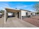 Front view of a charming house featuring a carport and manicured yard at 649 Federal St, Henderson, NV 89015