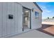 Front entrance of the house with a dark door and modern light fixture at 649 Federal St, Henderson, NV 89015