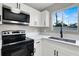 Modern kitchen featuring stainless steel appliances and white shaker cabinets at 649 Federal St, Henderson, NV 89015