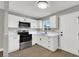 Modern white kitchen with stainless steel appliances and quartz countertops at 649 Federal St, Henderson, NV 89015