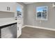 Updated kitchen with white shaker cabinets and stainless steel dishwasher at 649 Federal St, Henderson, NV 89015