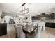 Open concept floor plan features a dining area adjacent to a kitchen with dark cabinetry and a light countertop at 7073 Range Valley St, North Las Vegas, NV 89084