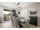 Bright dining area with modern chandelier, patio doors, and access to an outdoor living space at 7073 Range Valley St, North Las Vegas, NV 89084