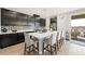 Modern kitchen with stainless steel appliances, a spacious island with seating, and decorative backsplash at 7073 Range Valley St, North Las Vegas, NV 89084