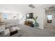 Relaxing upstairs living area with gray carpet, media console, and ample natural light at 7073 Range Valley St, North Las Vegas, NV 89084