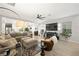 Open concept living room with stylish furniture, a ceiling fan, and neutral decor adjacent to the kitchen and dining areas at 7073 Range Valley St, North Las Vegas, NV 89084